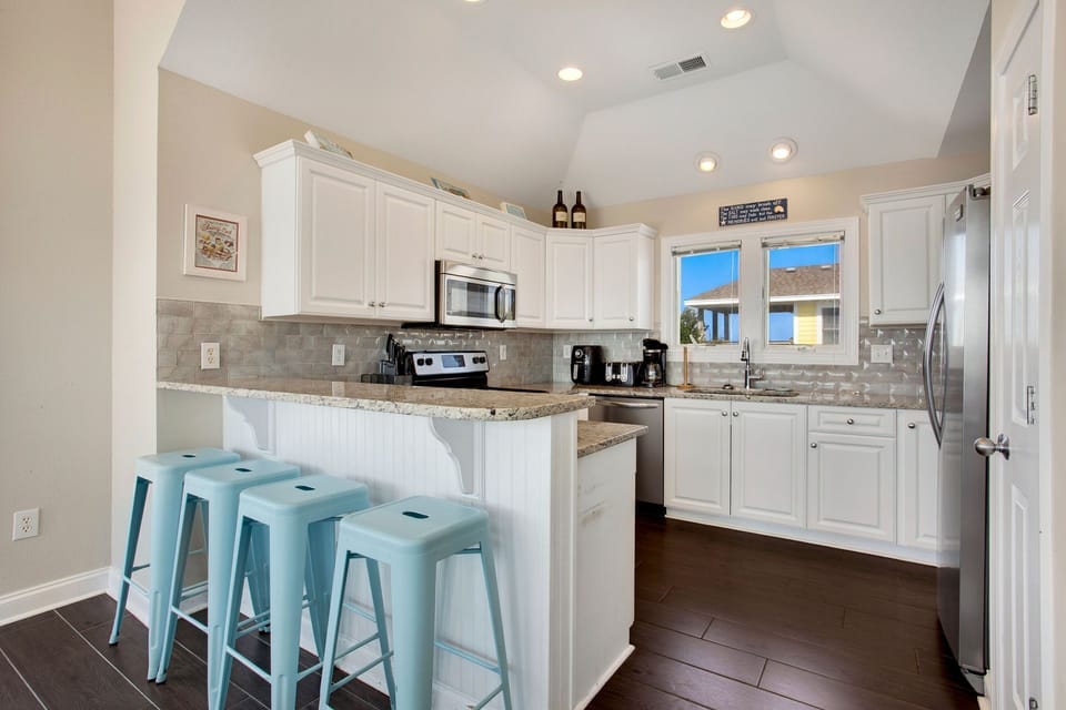 Whip up something delicious in the Open Kitchen with Bar Seating.