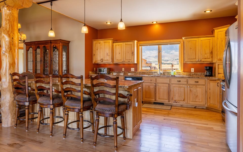The open kitchen and breakfast bar make for easy meal prep while visiting