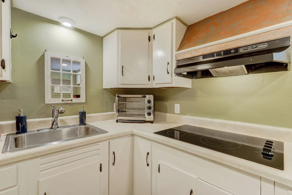 Toaster oven, sink, cabinets and range