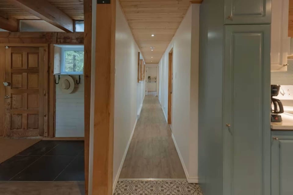 Long hallway leading from the entrance to the living spaces