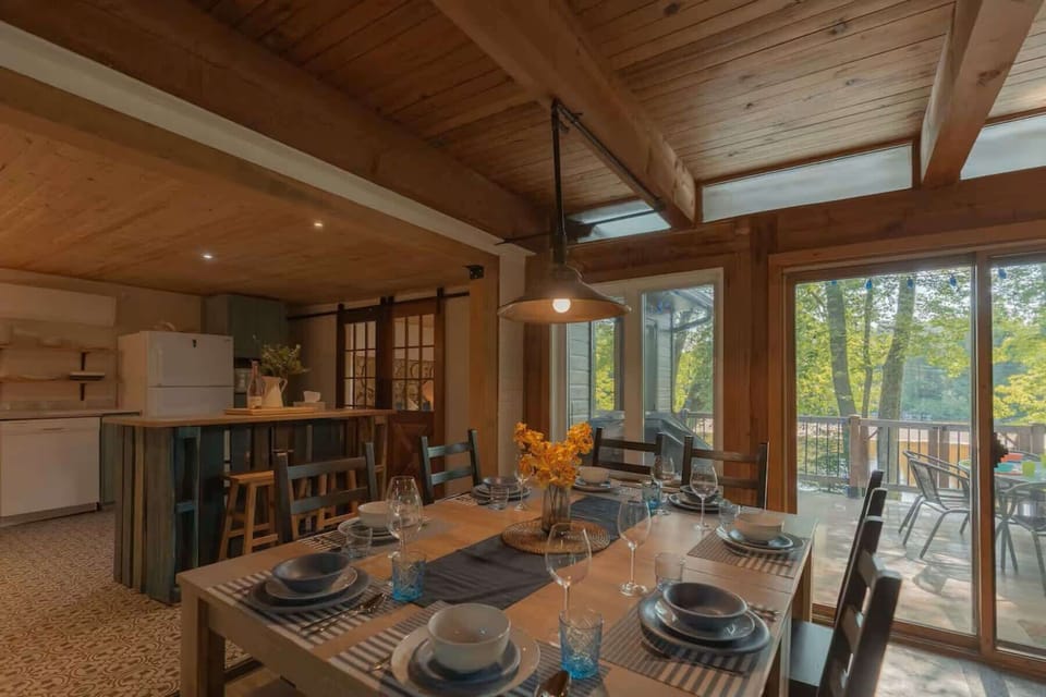 Bright dining area with forest views and direct access to the outdoor deck