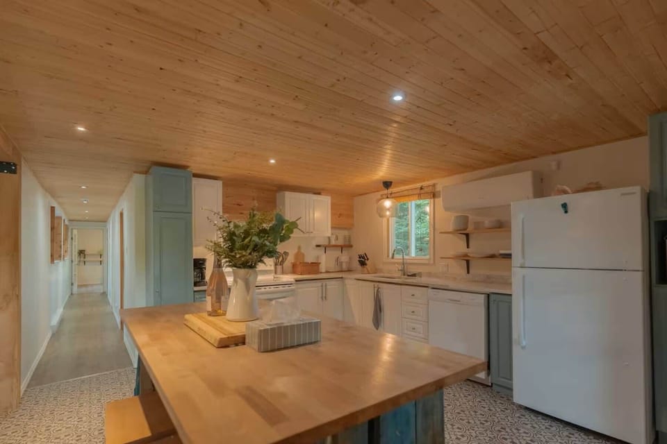 Fully equipped kitchen with modern appliances and wood finishes