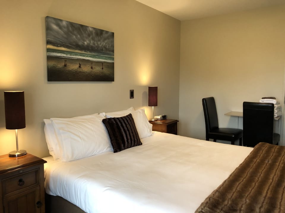 Premium bedding, desk, laptop workspace, blackout drapes