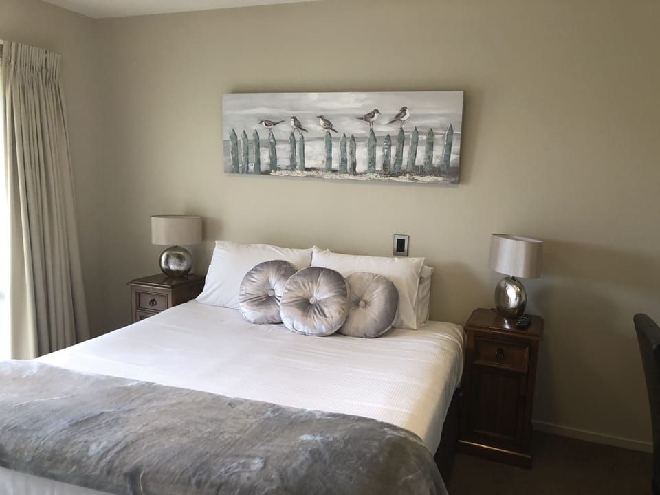 Premium bedding, desk, laptop workspace, blackout drapes