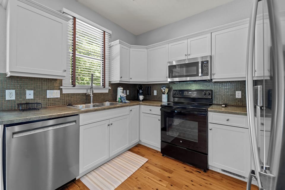 Kitchen Area on First Level with Patio Access