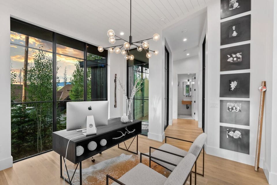 Finally, after walking through a glass hallway, to the office where connection to business life can be maintained. Access to printer if you need a quick print. WiFi Boosters thru out our home make access easy.