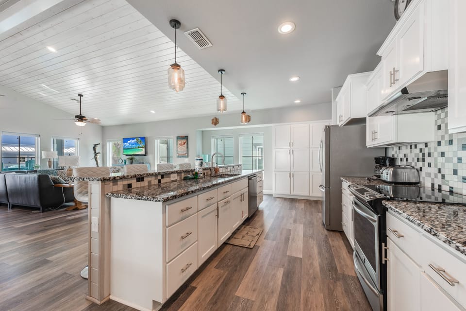 Your spacious gourmet kitchen awaits with granite countertops, premium appliances, and a large island perfect for cooking memorable meals together.
