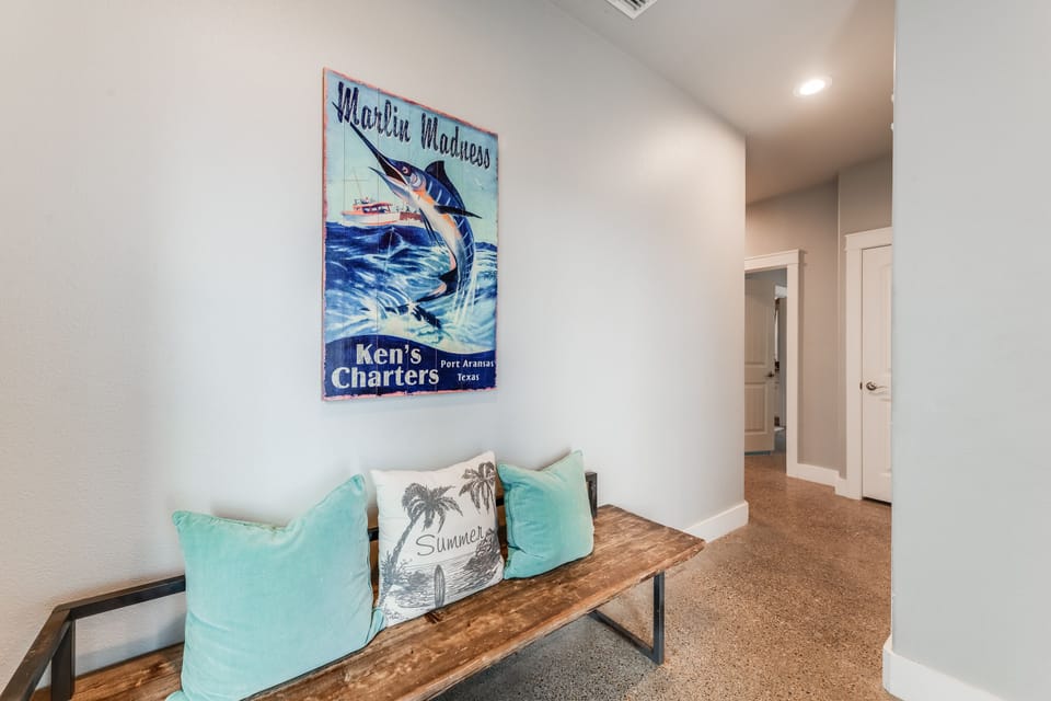 Step into your coastal retreat where nautical artwork and turquoise accents create a welcoming atmosphere that instantly puts you at ease.