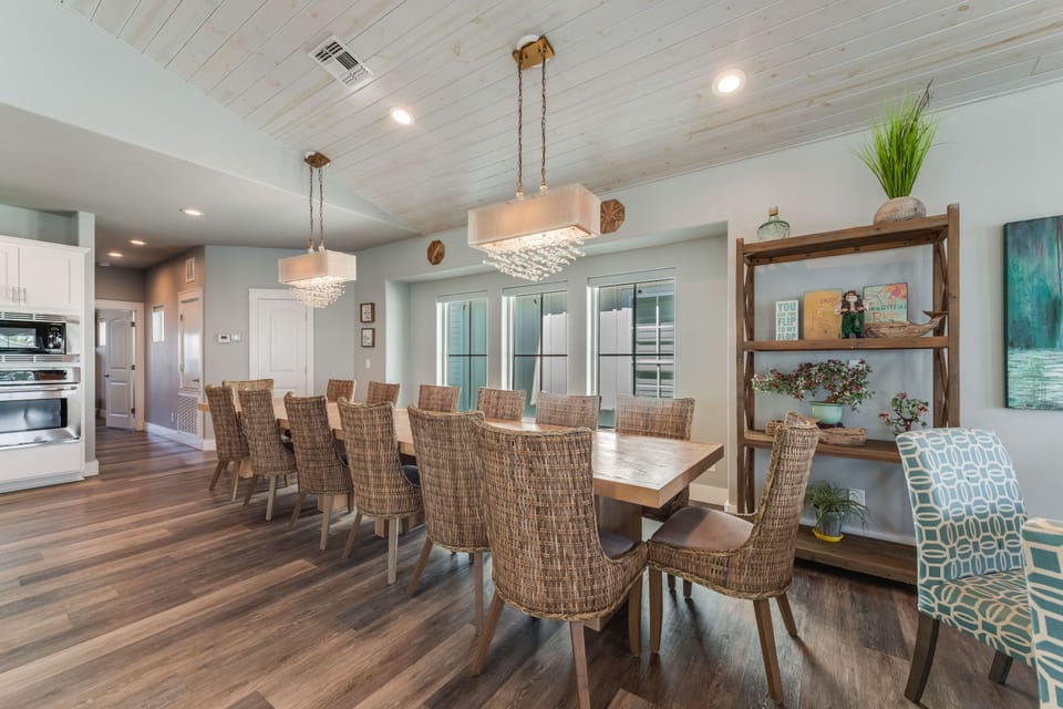 Gather your group around this stunning dining table where coastal elegance meets comfort in your spacious retreat.