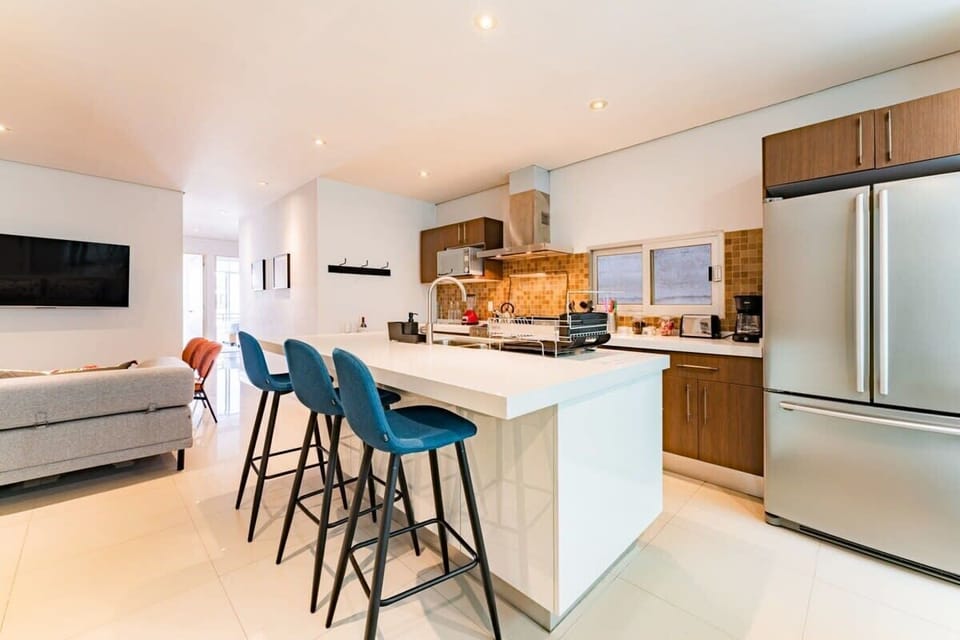 The island provides extra counter space for easy meal prep and chairs to enjoy a quick snack