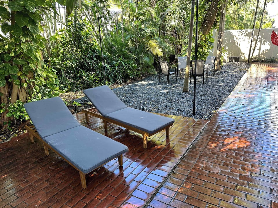 Shared backyard space includes lounge chairs for relaxation.