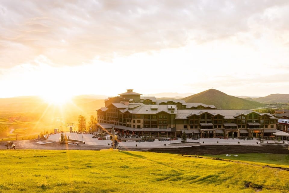 Experience warm sunsets over lush green grounds as daylight fades into evening.
