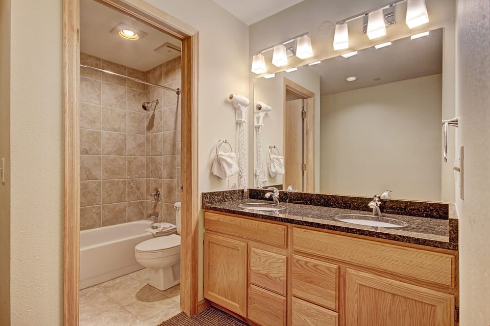 Get ready for the day ahead in the bright full bathroom.