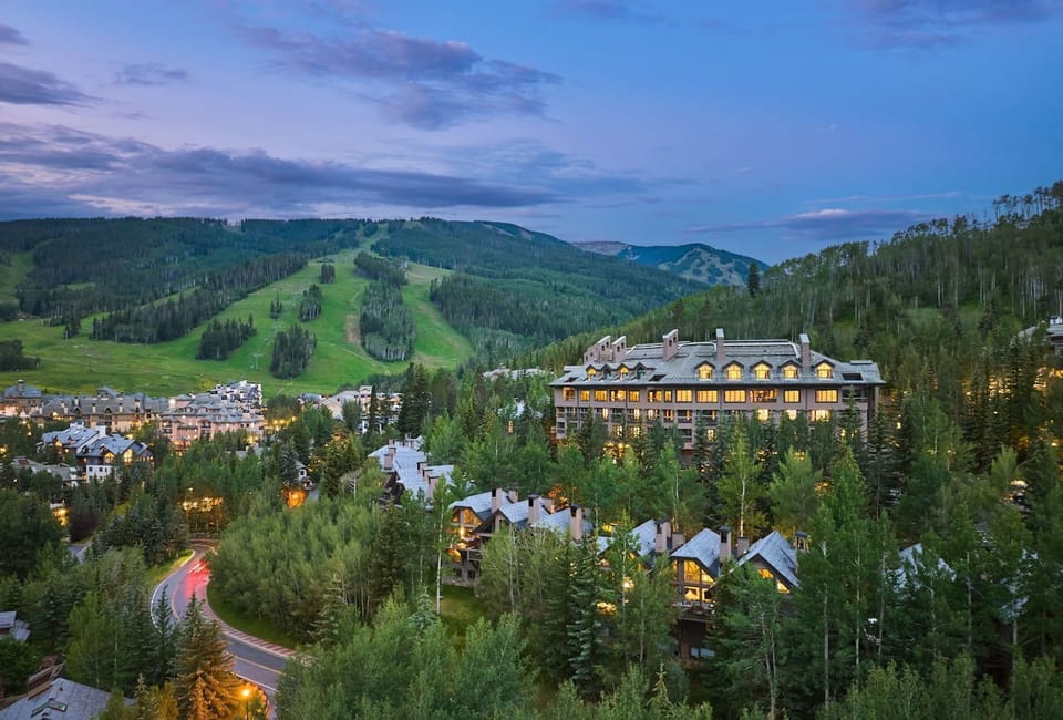 As evening falls, glow with warmth from the lodge, embraced by the stunning mountain backdrop.