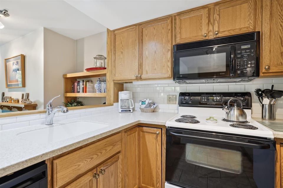 Modestly stocked kitchen.
