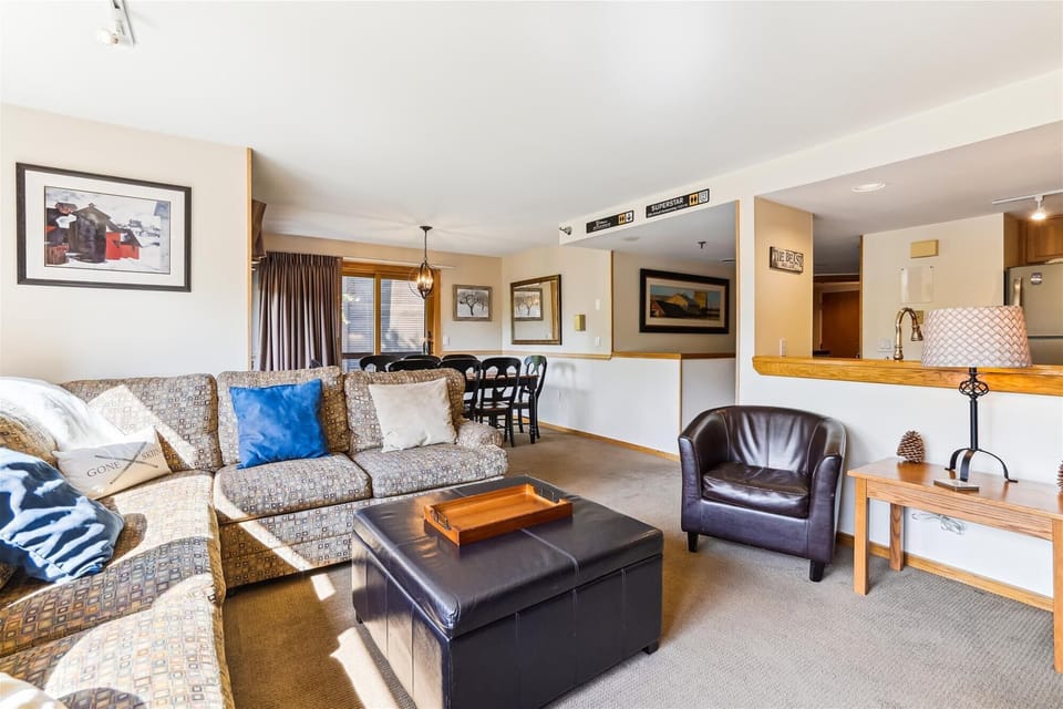 Open-concept living room flowing into the dining area and kitchen, ideal for gathering after a day on the mountain.
