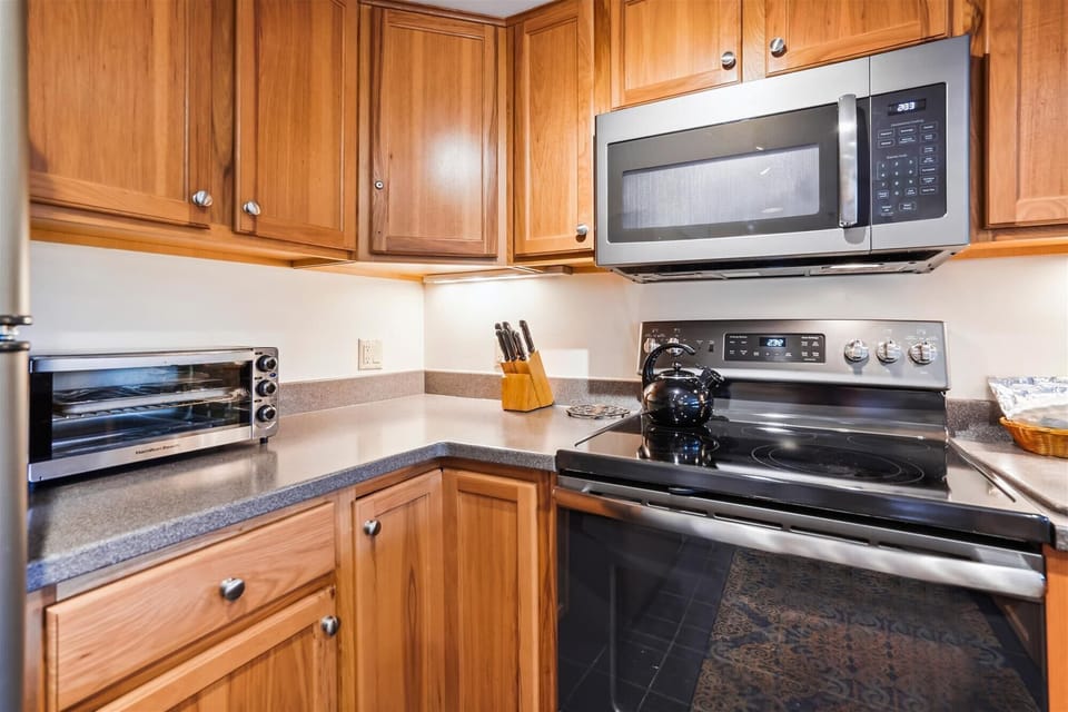 Full kitchen featuring updated appliances, ample cabinetry, and everything needed for easy meals during your stay.