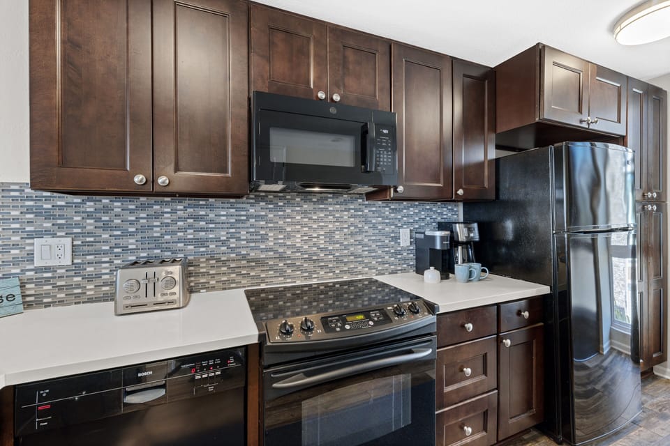 The heart of this beachfront retreat – a fully equipped kitchen with modern amenities, perfect for preparing delicious feasts and creating lasting memories.