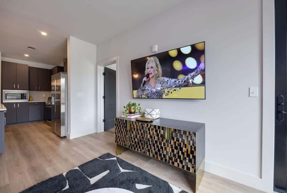 Open concept living area with floor to ceiling windows! Features designer furniture and smart TV!