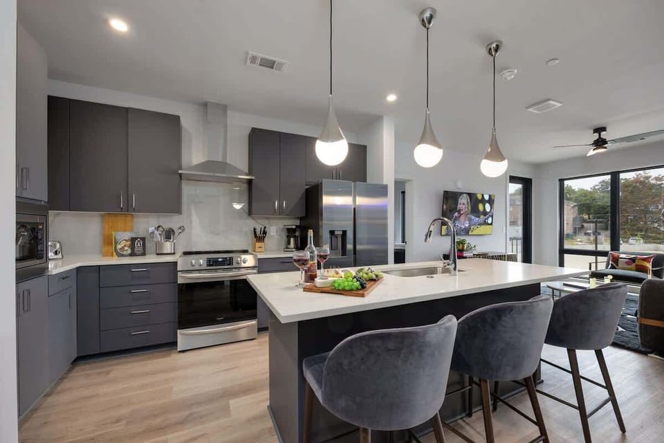 Fully equipped kitchen stocked with your basic cooking essentials. Includes stainless steel appliances and small kitchen island with bar seating.