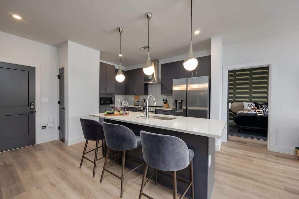Fully equipped kitchen stocked with your basic cooking essentials. Includes stainless steel appliances and small kitchen island with bar seating.