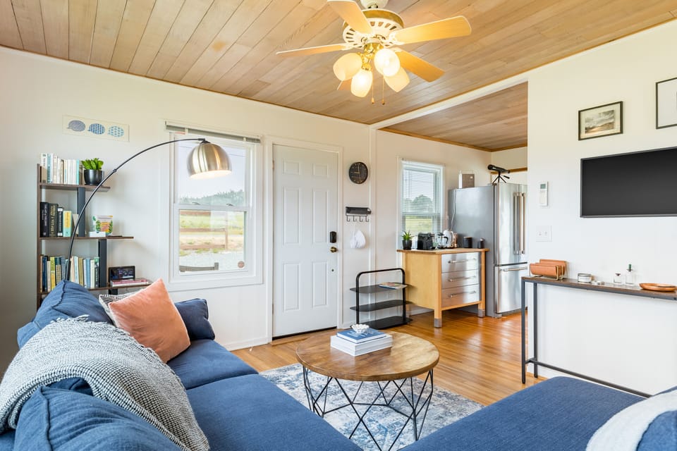 Elegant living room gleaming with hardwood floors.