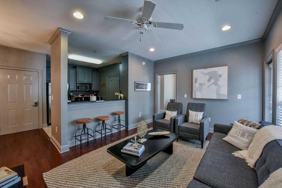 Living Room - The living room has a spacious couch along with two other chairs so everyone in your group can sit and watch a movie or the Alabama Football Game.