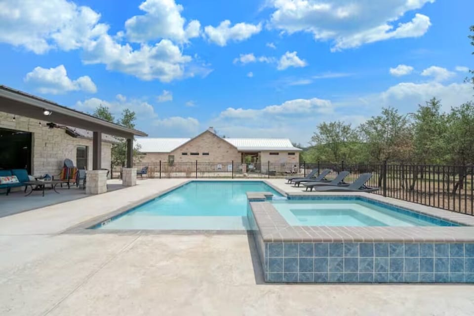 Amazing pool patio with lounging, splashing, and soaking in the hot tub.