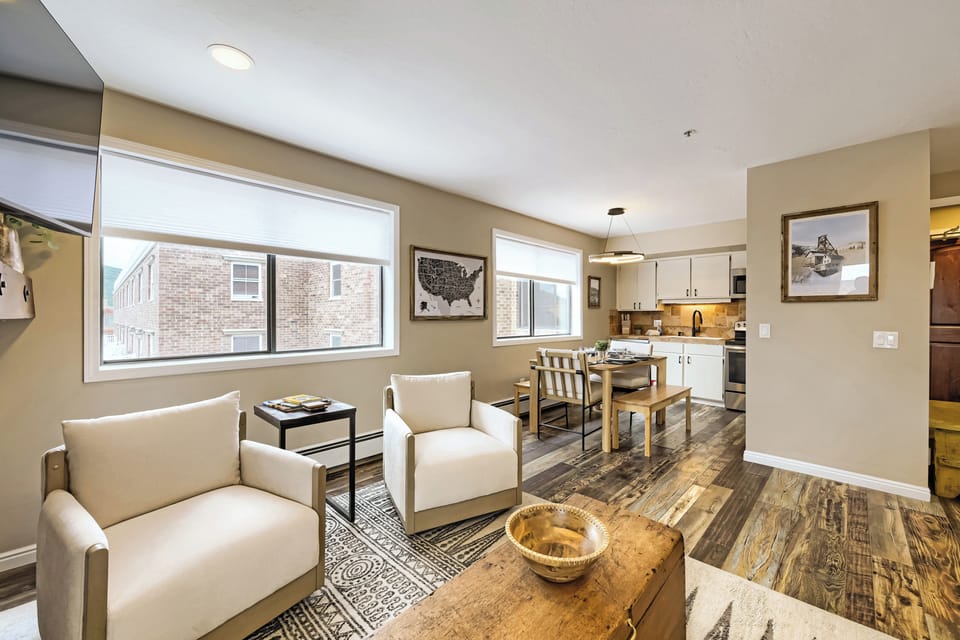 Open-plan living with natural light and modern comfort awaits. Sink into plush seating, gather at your dining table, and enjoy a fully-equipped kitchen—all framed by warm tones and charming details for your getaway.