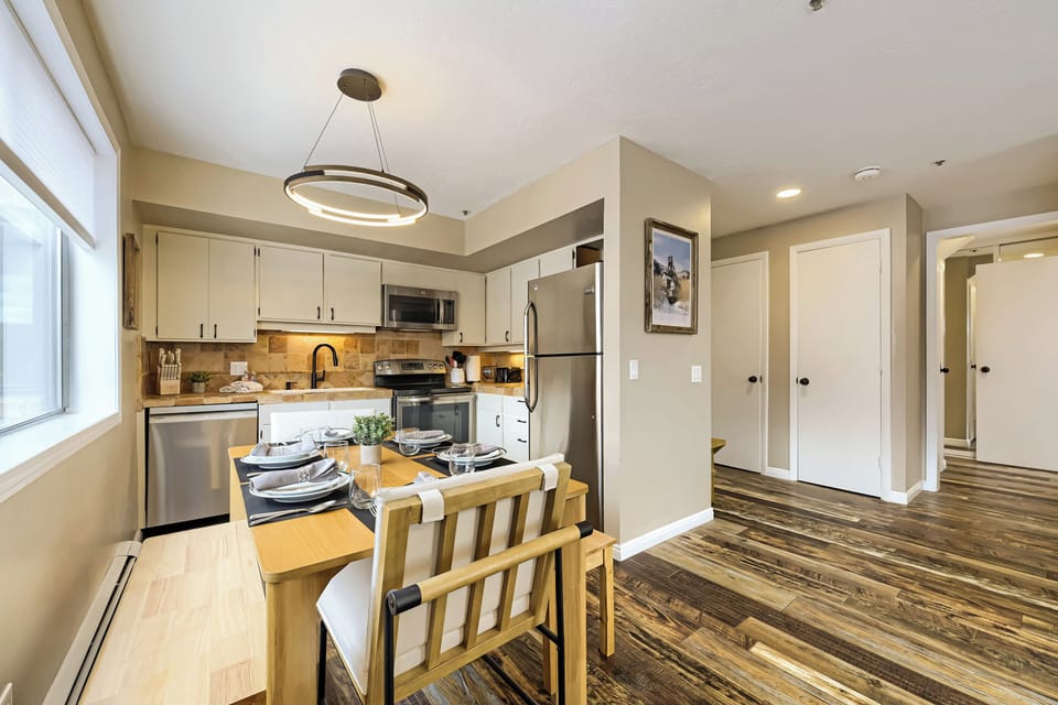 Your fully equipped kitchen and dining space welcomes you home with warm lighting, modern appliances, and all the comforts you need to cook and share meals together.
