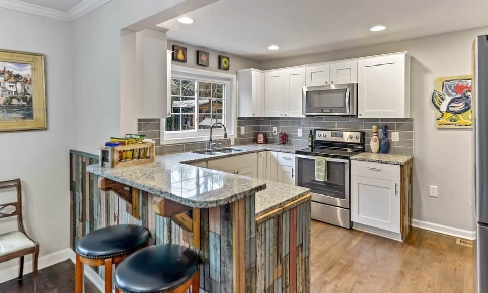 Our gorgeous granite, stainless kitchen is accented with 120 year old beaded board, and brackets made from 120 year old heart of pine floor joists.