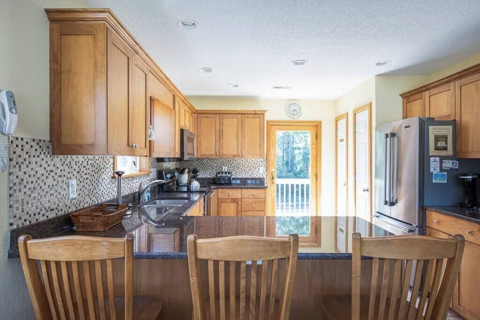 Fully Stocked Kitchen w/ Deck Access and bar seating for 3 (cooking utensils, microwave, electric range, Keurig & Drip, and many more)