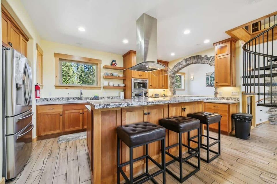 South Lake Tahoe cabin kitchen thoughtfully stocked with cookware, bakeware, dinnerware, serving pieces and utensils, providing families and groups with the essentials to prepare and enjoy meals together.
