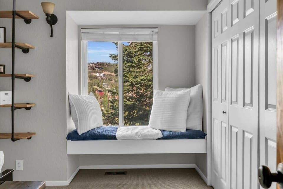 The window seat is a real highlight of the room, the perfect cozy spot to relax and take in the views.