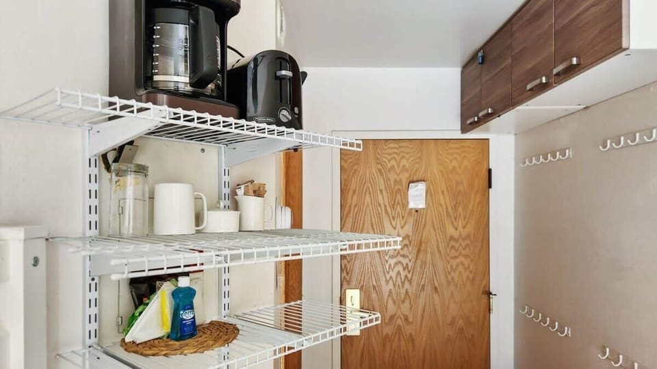 Shelves on either side of the room provide a convenient place to store personal items and groceries.