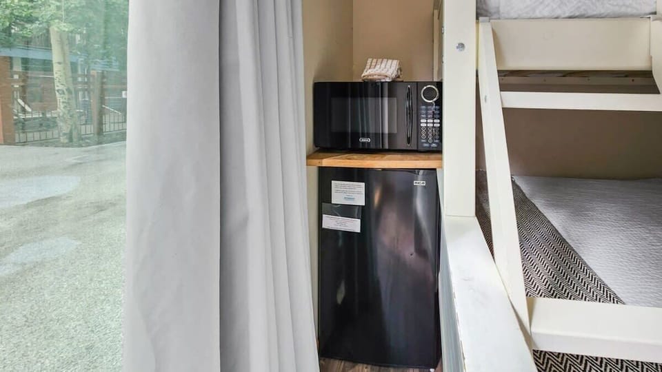 Tucked next to the bunk bed is a mini-fridge and a microwave so you can handle light meal prep right in your room.