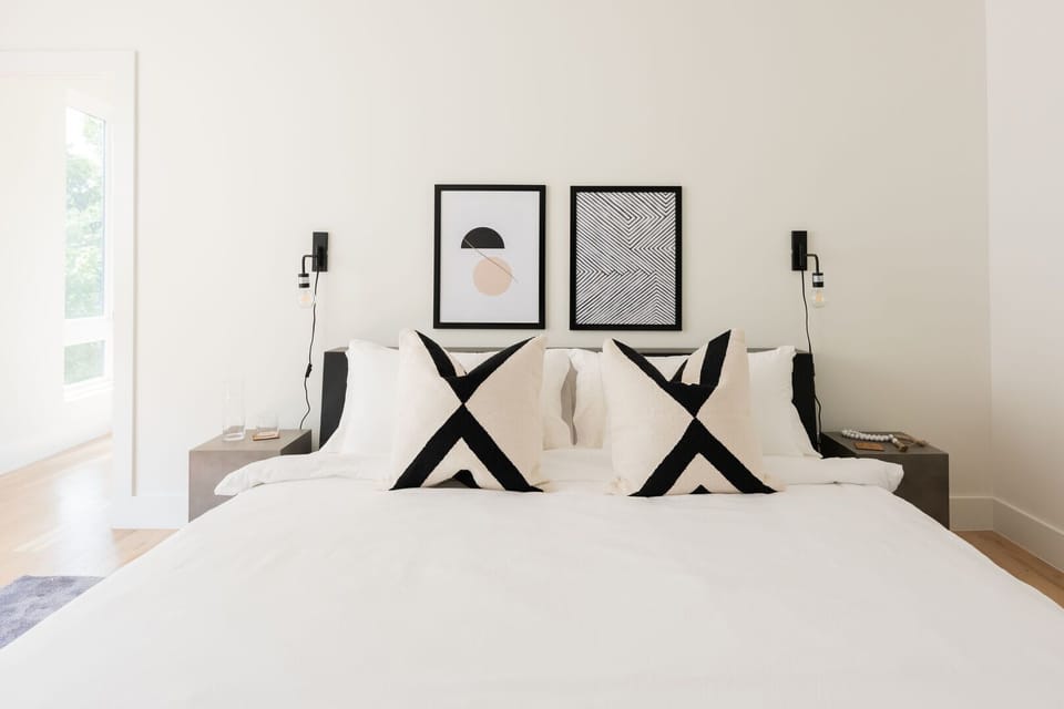 Queen bedroom with thoughtful decor and dual nightstands, a retreat when someone needs their own space in the house