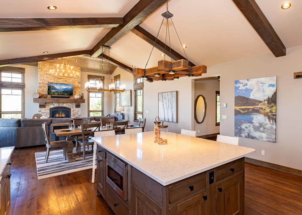 Open concept main level with living and dining areas, and kitchen.