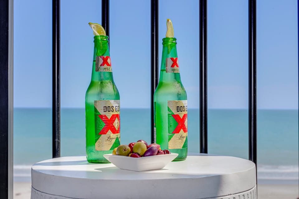 Enjoy a refreshing Peroni with a side of olives on your balcony, overlooking the waves. The perfect setting to unwind, sip, and savor the tranquil seaside ambiance, turning a simple moment into a memorable escape.