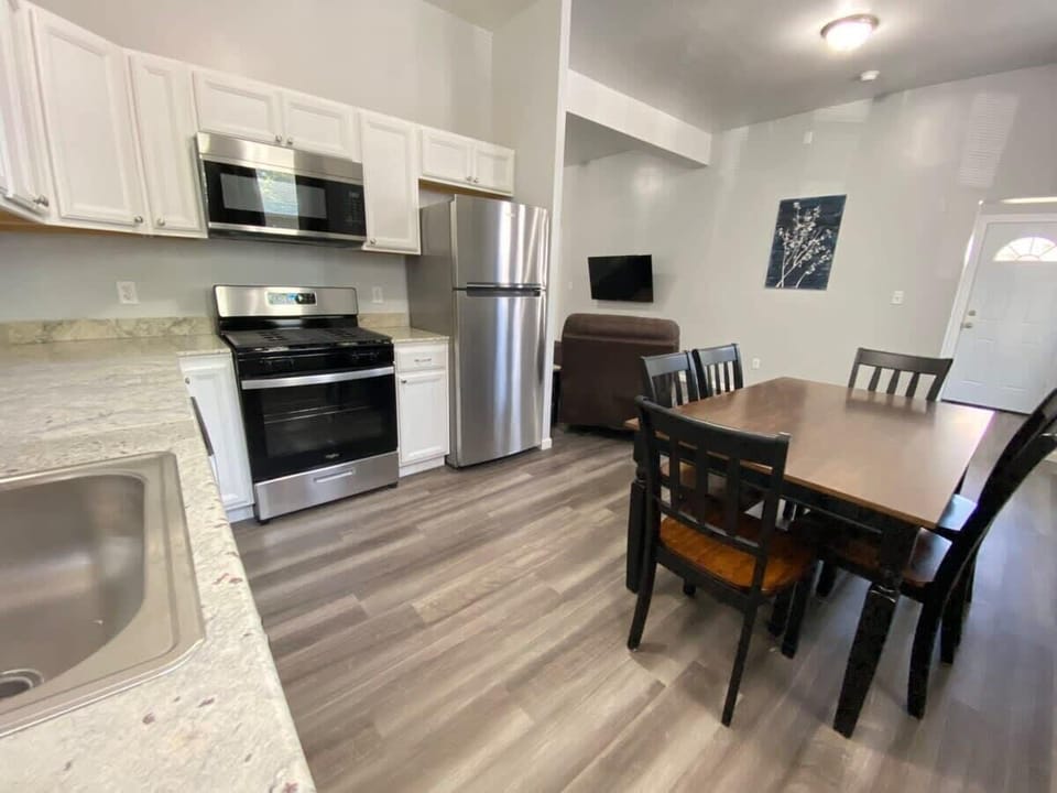 This fully equipped kitchen has everything you need to prepare meals, featuring modern appliances, cooking utensils, pots, pans, and all the essentials for a stress-free cooking experience.