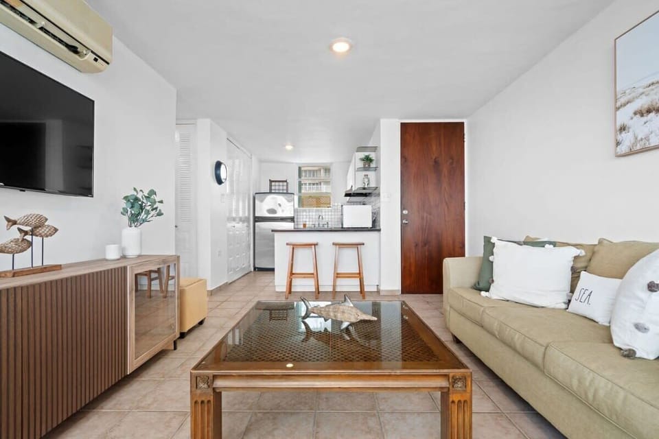 The living room is adjacent to the kitchen and the dining area