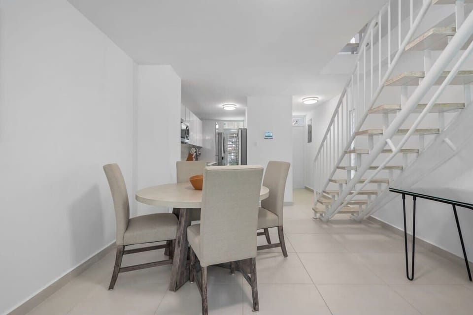 The dining table seat 4 guests and it is right besides the kitchen and living room.