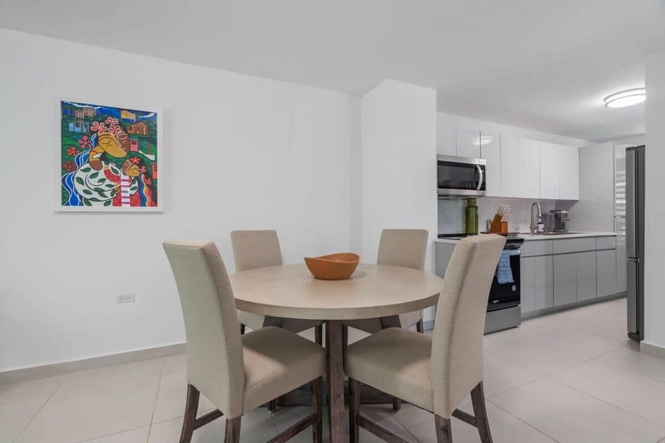 The dining table seat 4 guests and it is right besides the kitchen and living room.