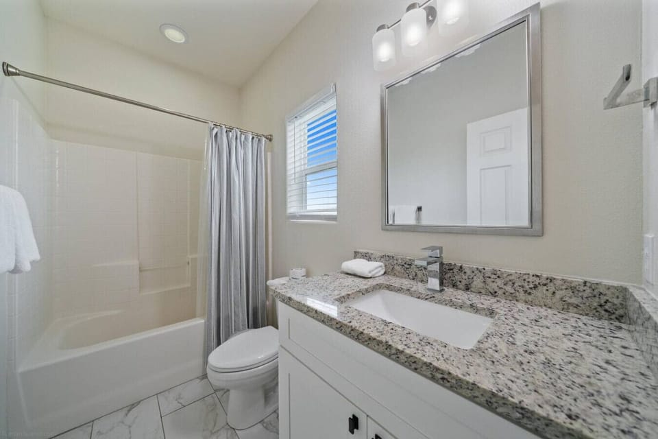 `Sparkling Full Bathroom – Granite Vanity & Shower/Tub Combo with Beachy Touches`