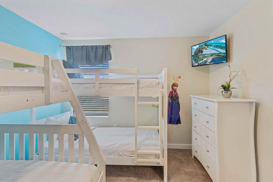 Bedroom 3 at Vista Cay Resort boasts three single beds and one double bed, providing ample space to rest and recharge after a day of adventure.