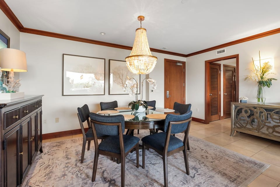 Gather around your elegant dining table under the stunning chandelier for memorable meals with loved ones.