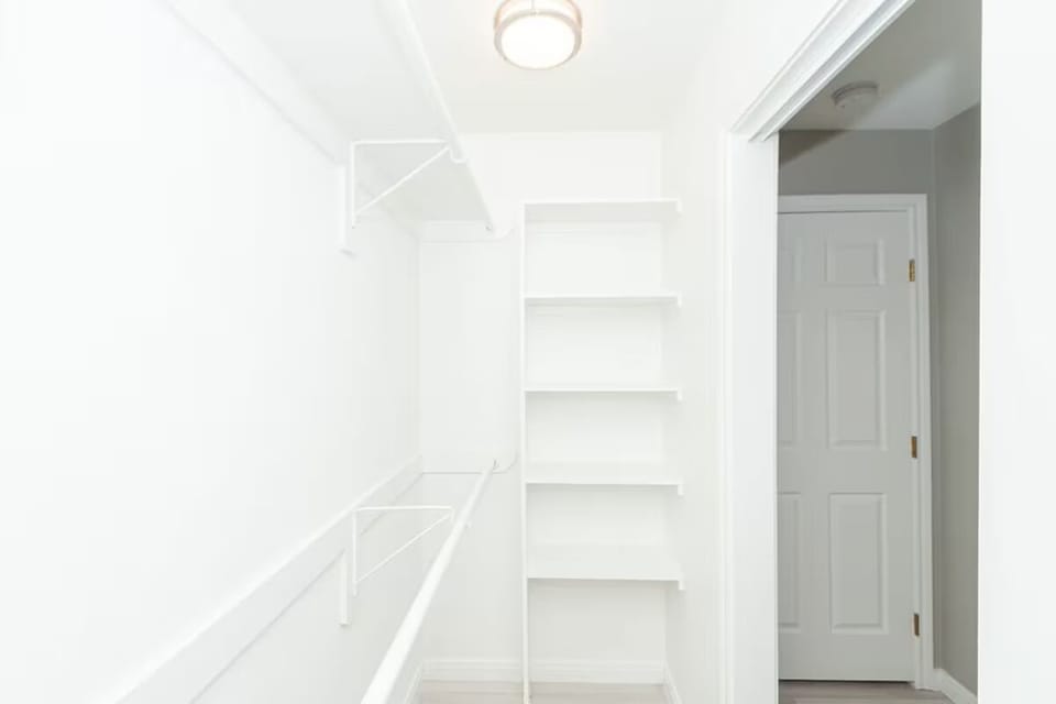 Primary bedroom walk-in closet.