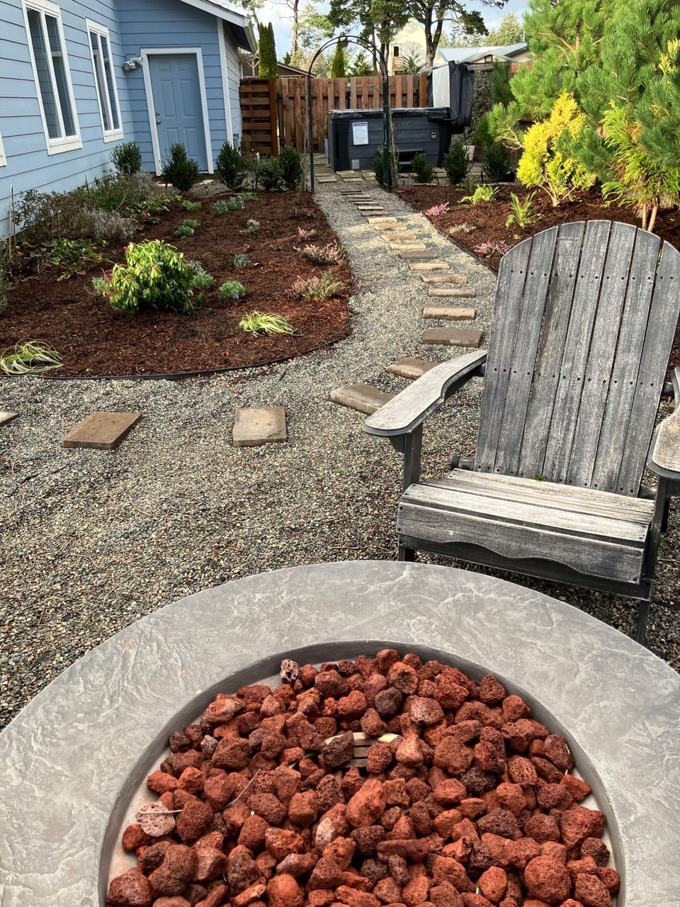 Fire pit area with view of hot tub.