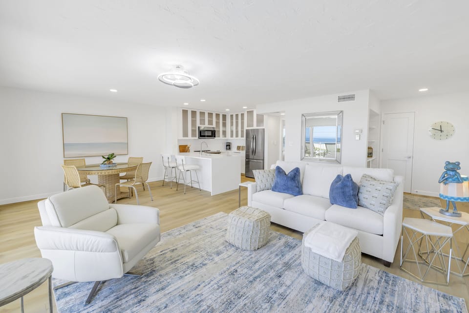 Spacious and sunny living area leading to dining.
