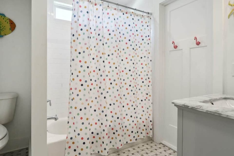 Shared full bathroom for the 2nd & 3rd bedrooms on main floor includes a tub/shower combo